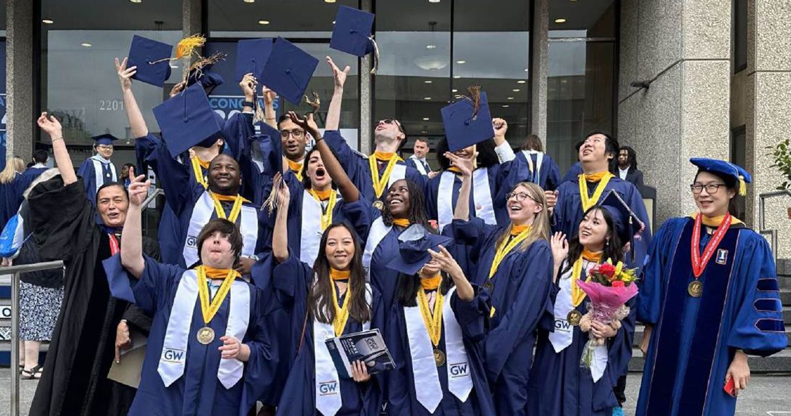 Biochemistry Graduates Outside tossing their graduation caps